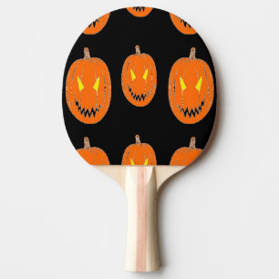 Orange pumpkin on black ping pong paddle