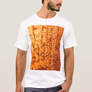 Orange raindrops on glass, abstract background. T-Shirt