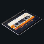 Orange Retro Audiotape 70th birthday Guest Book<br><div class="desc">Old audio cassette to personalise with your name and date. Design on spiral notebook with text for 70th Birthday party guest book in horizontal orientation. You can easily change text (font, colour, size and position) by clicking the customise button. Available in hard cover guest book. Matching birthday save the date...</div>