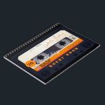 Orange Retro Audiotape 70th birthday Guest Book<br><div class="desc">Old audio cassette to personalise with your name and date. Design on spiral notebook with text for 70th Birthday party guest book in horizontal orientation. You can easily change text (font, colour, size and position) by clicking the customise button. Available in hard cover guest book. Matching birthday save the date...</div>