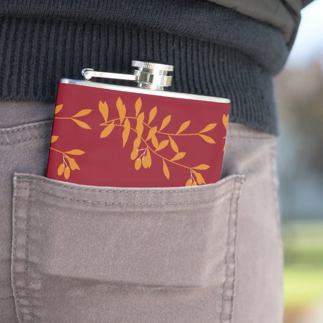 Orange silhouette branch leaves on red hip flask (In Situ)