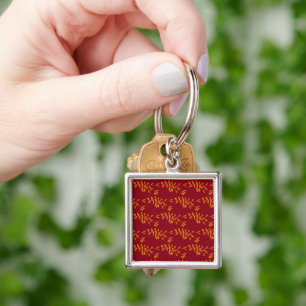 Orange silhouette branch leaves on red key ring