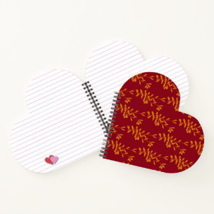 Orange silhouette branch leaves on red notebook