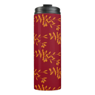Orange silhouette branch leaves on red thermal tumbler