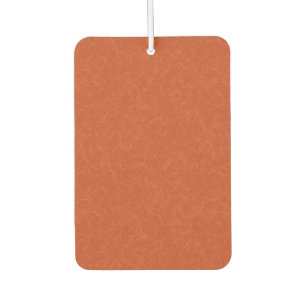 Orange textured surface with swirling pattern car air freshener