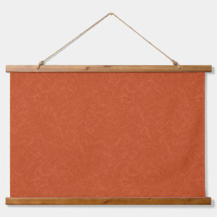 Orange textured surface with swirling pattern hanging tapestry