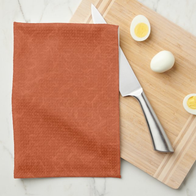 Orange textured surface with swirling pattern tea towel (Quarter Fold)