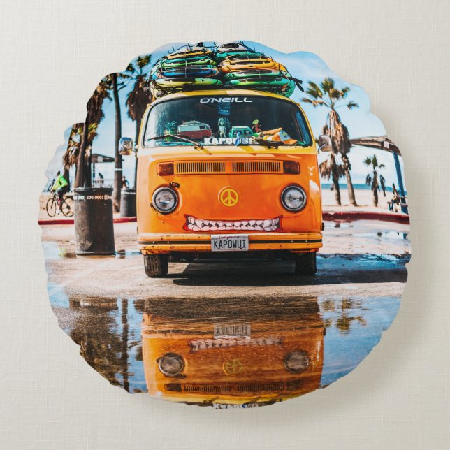 Orange van with surfboard on top round cushion (Front)