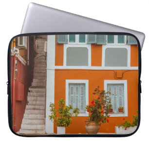 ORANGE WHITE AND GRAY CONCRETE BUILDING LAPTOP SLEEVE