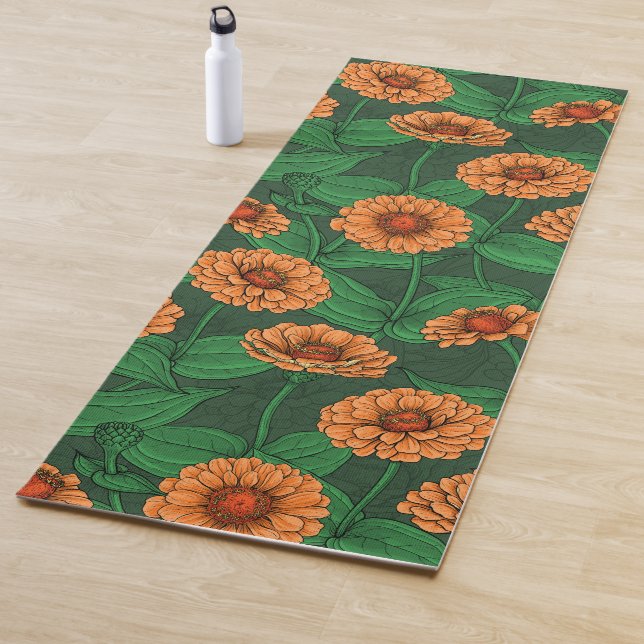 Orange Zinnia flowers, green leaves on dark green Yoga Mat (In Situ)