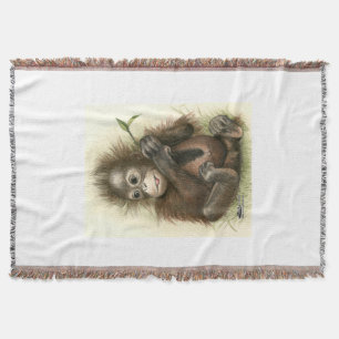 Orangutan Baby With Leaves Throw Blanket