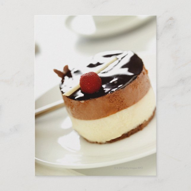 Ornate cheesecake on plate with coffee cup in postcard (Front)