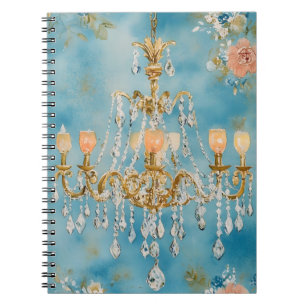 ornate crystal chandelier with an antique gold-ton notebook