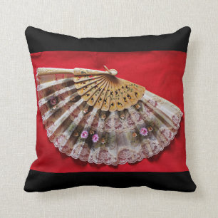 Ornate Hand Held Fan on a Red Background Cushion