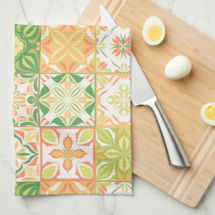 Ornate tiles in green and yellow tea towel