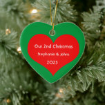 Our Second Christmas Together Cute Red Heart 2023  Ceramic Tree Decoration<br><div class="desc">Personalised names and printed with cute red heart design in solid green background. Feel free to customise by adding your own texts,  names or photos. You can add your photo on the back side of the ornament easily!
The colour of the background can also be changed as you want.</div>