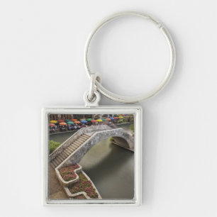 Outdoor cafe along River Walk and bridge over Key Ring