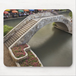 Outdoor cafe along River Walk and bridge over Mouse Mat