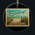 Outer Banks Beach Vintage Travel Ceramic Tree Decoration<br><div class="desc">This Greetings From Outer Banks vintage postcard design features a sandy beach with a beautiful turquoise ocean water and above the sea,  a blue sky with billowy white clouds. In vintage travels style.</div>