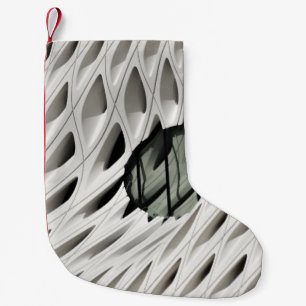 Oval black tint glass panel on white surface small christmas stocking