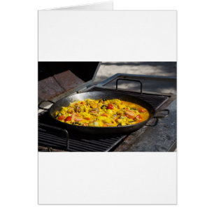 Paella is cooked on a grill