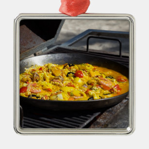 Paella is cooked on a grill metal tree decoration