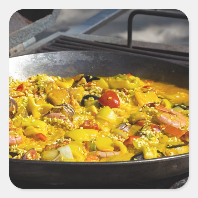 Paella is cooked on a grill square sticker (Front)