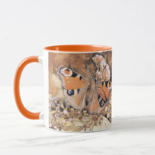 Painting of an orange and black butterfly on flowe mug