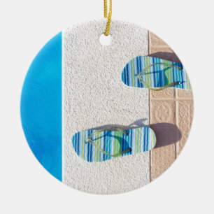 Pair of slippers at edge of swimming pool ceramic tree decoration