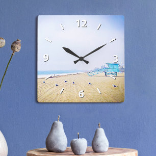 Pale blue sky and light golden sandy beach photo square wall clock