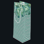 Palm Beach Christmas Wine Gift Bag<br><div class="desc">Tropical style gift bag features a replica of my original hand painted watercolor monstera leaves with pink and green stripes. These gift bags coordinates beautifully with Do Tell A Belle's Palm Beach Christmas suite. Perfect for holiday wine gifts for the wine lover in your life. To see matching items visit...</div>