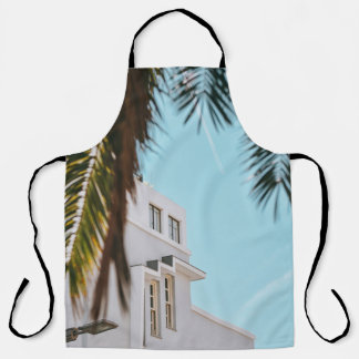 Palm tree near white concrete building apron