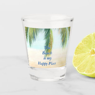 Palm tree on a sunny day on the beach shot glass