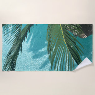 palm tree over the water beach towel