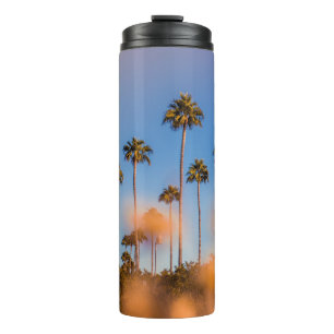 Palm tree under blue sky thermal tumbler