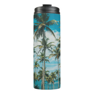 Palm trees above the ocean, vintage toned and retr thermal tumbler