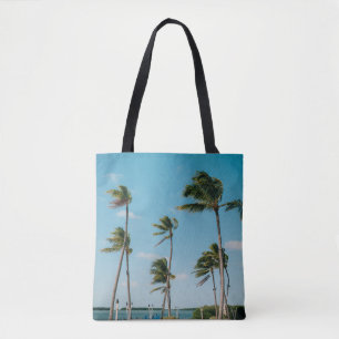 Palm trees on beach shore in the morning tote bag