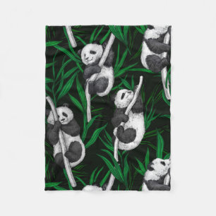 Panda cubs on dark green fleece blanket