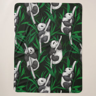 Panda cubs on dark green sherpa blanket