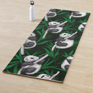 Panda cubs on dark green yoga mat