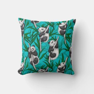 Panda cubs on turquoise cushion