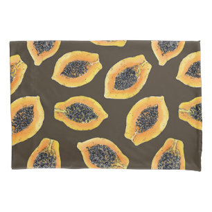 Papaya slices on dark brown pillowcase