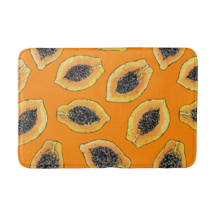 Papaya slices on orange bath mat