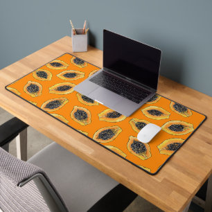 Papaya slices on orange desk mat