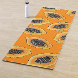 Papaya slices on orange yoga mat