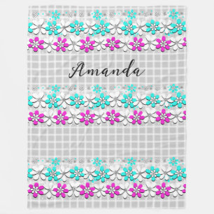 Paper neon flowers on a grey-white chequered fleece blanket