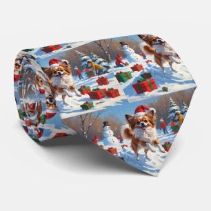 Papillon Dog Running in Snow with Christmas Hat Tie