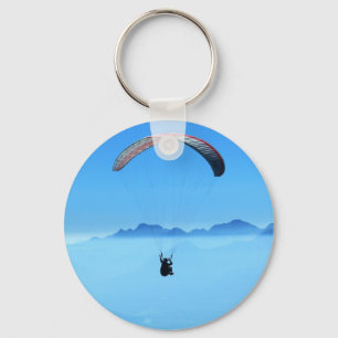 Paraglider on blue background with mountains key ring