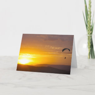 Paragliding on the sunset card