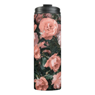 Pastel pink roses growing in the garden in soft li thermal tumbler